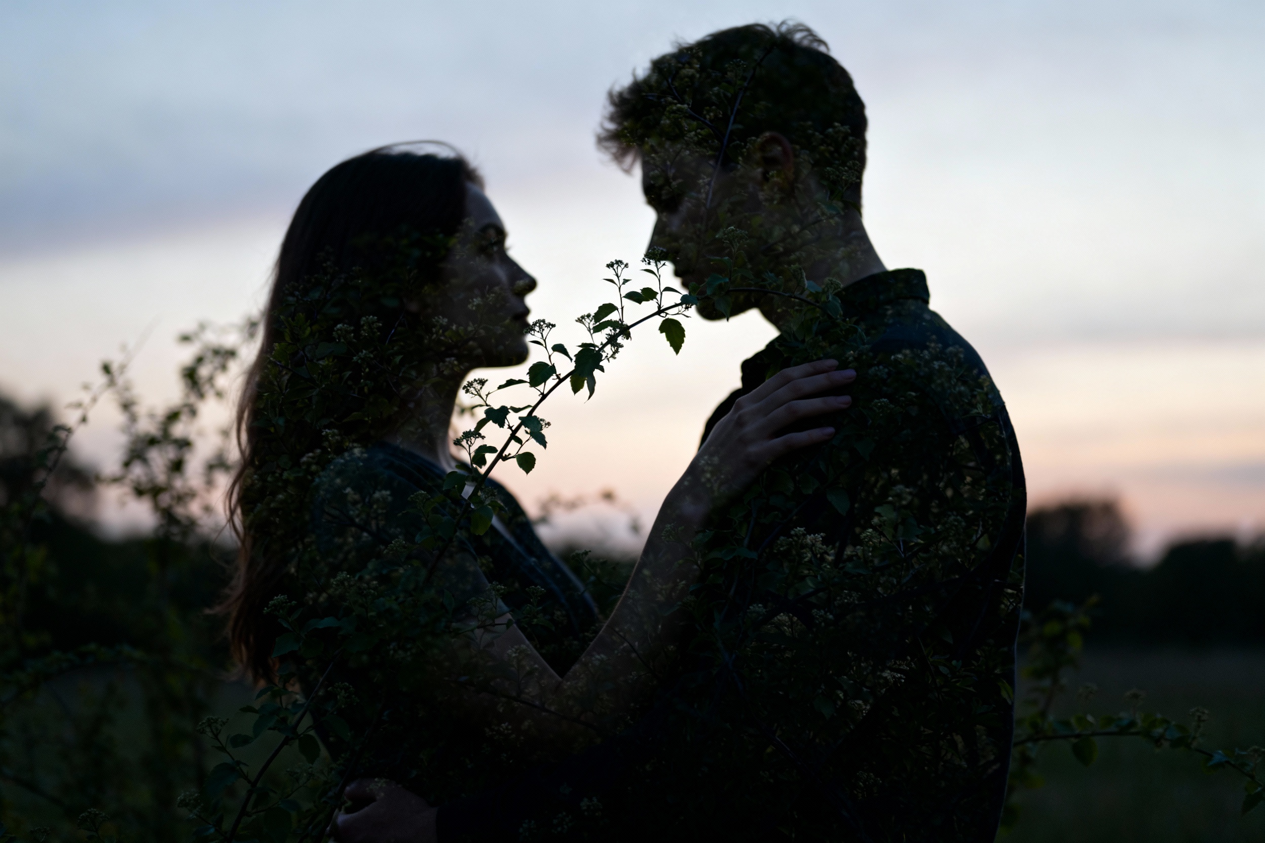An abstract composition of soft, blurred silhouettes of people intertwined with nature, symbolizing...
